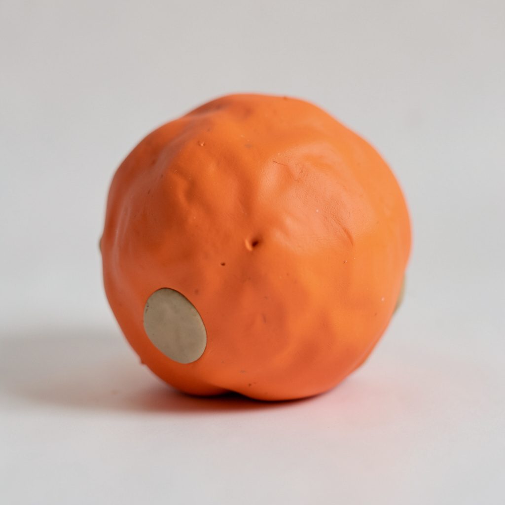 A cluster of translucent spherical forms in soft ivory and amber tones, suspended as if floating in quiet equilibrium